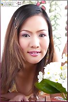  leaning forward smelling flowers aroma