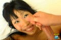 Cat on her back looking up smiling broadly waiting for facial cumshot