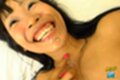 On her back smiling broadly cum on her face