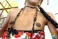 Tong lowering dress exposing her small breasts wearing necklace