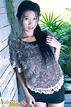 Focus Wan standing against wall long hair short skirt