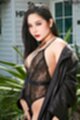 Long hair falling over her shoulder wearing sheer lingerie