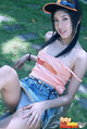 Yoko seated on bench strap falling from shoulder skirt riding up exposing her panties