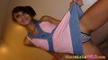 Pulling hem of dress up revealing her panties