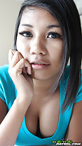 Chin resting on hand wearing green topm showing cleavage